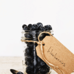 fresh blueberries in a mason jar with craft tag