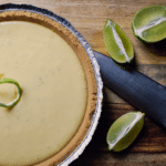 frozen lemon/lime pie with fresh citrus beside it