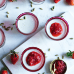 dishes willed with jelled milk dessert with fresh strawberries and strawberry jam