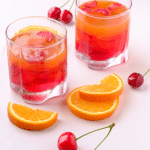 colorful jello in cups with fresh fruit surrounding