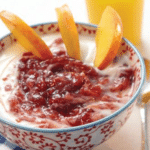 decorated bowl with yogurt, jam and sliced peaches