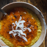 bowl of food topped with persimmon jam and shredded coconut