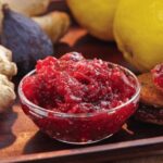 glass bowl full of gingered-lemon-fig preserve surrounded by the ingredients