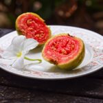 halved guava on a white plate