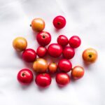 vibrant ground cherries on a white fabric