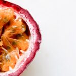 sliced open passion fruit on a white table.