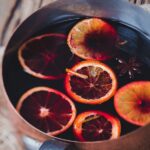 pot of sliced citrus floating in mulled merlot with spices