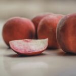 fresh nectarines and a slice of nectarine on a table