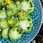 sliced tomatoes on an ornate blue plate