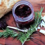blackberry jam surrounded by french bread and rosemary