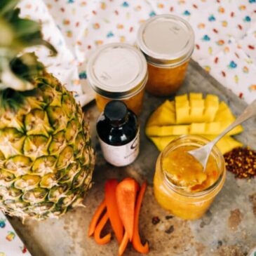 carolina reaper, pineapple and mango jam ingredients on a metal tray