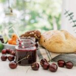 cherry habanero lime jam surrounded by ingredients, bread and culinary tools
