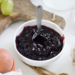 Plum jam in a bowl with a spoon